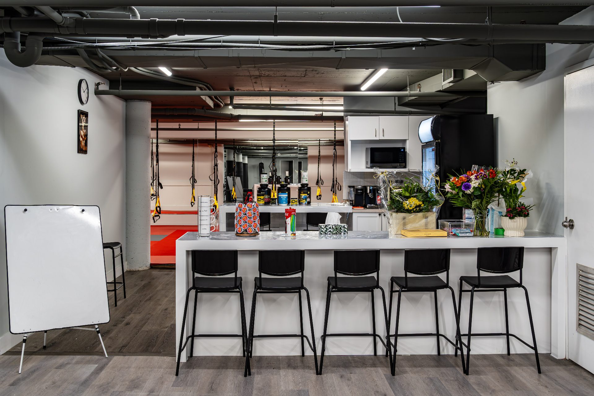 Member lounge and smoothie bar seating with view into the training floor
