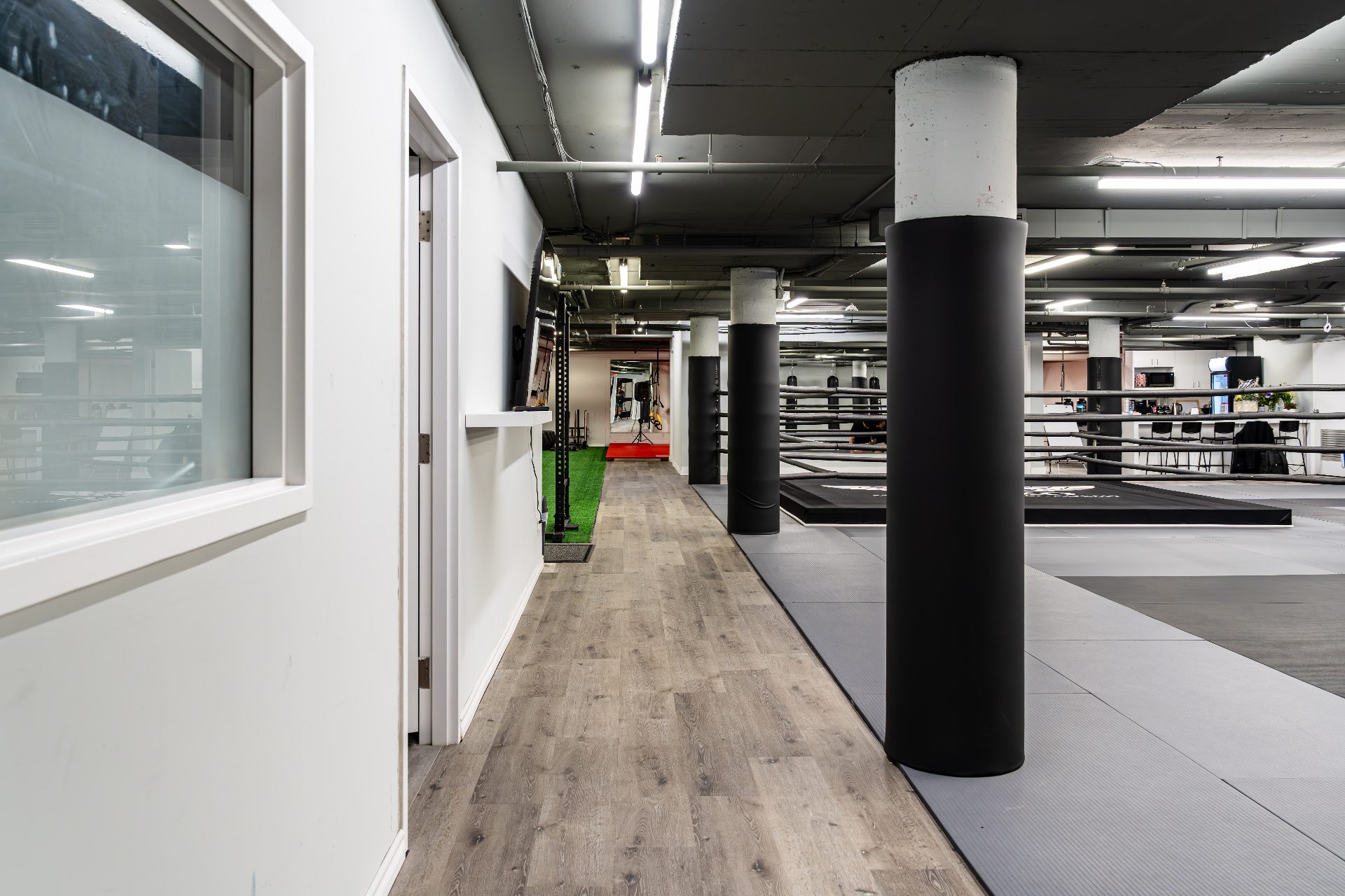 Hallway from the gym entrance leading past the ring and bag area
