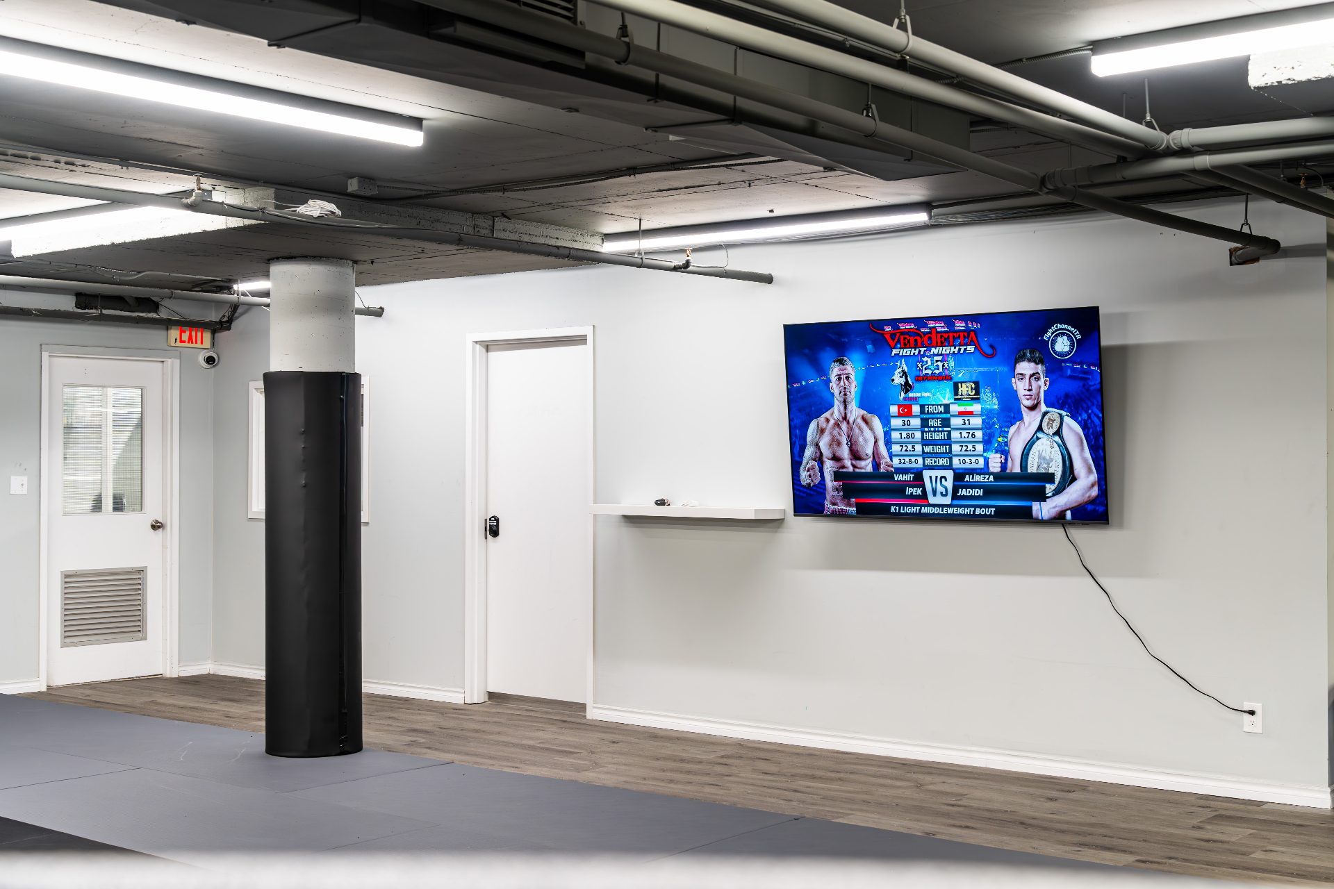 70-inch fight broadcast screen at the gym entrance